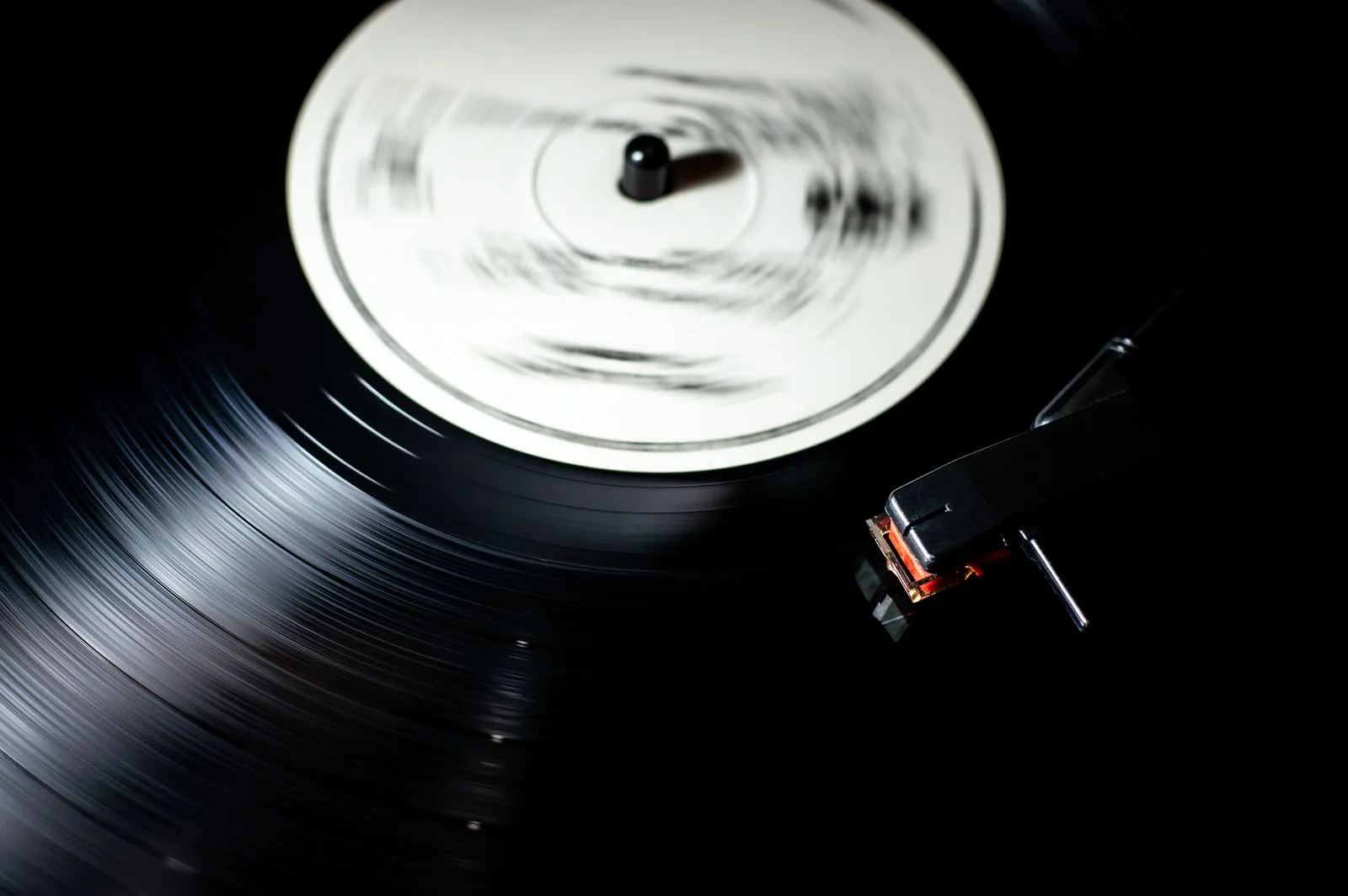 A vintage vinyl record spinning on a turntable, evoking the recorded-music era covered by this quiz category